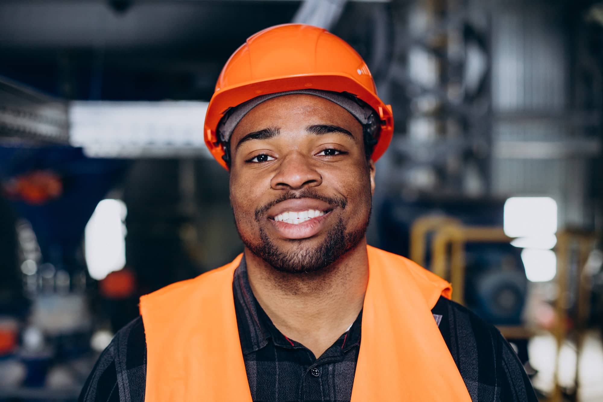 Headshot of a factory working wearing a helmet